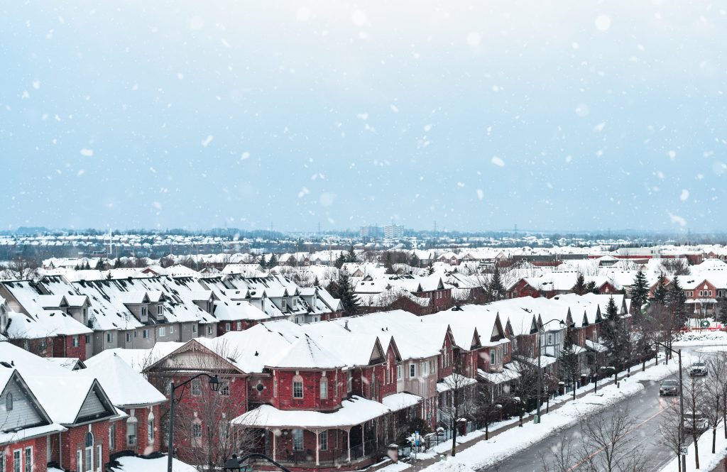 a small town in winter during snowfall