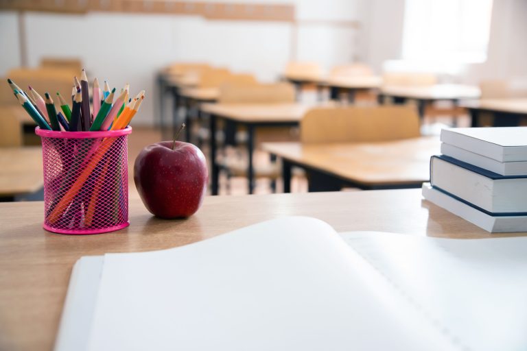 Pencils and books in the classroom. Education concept.
