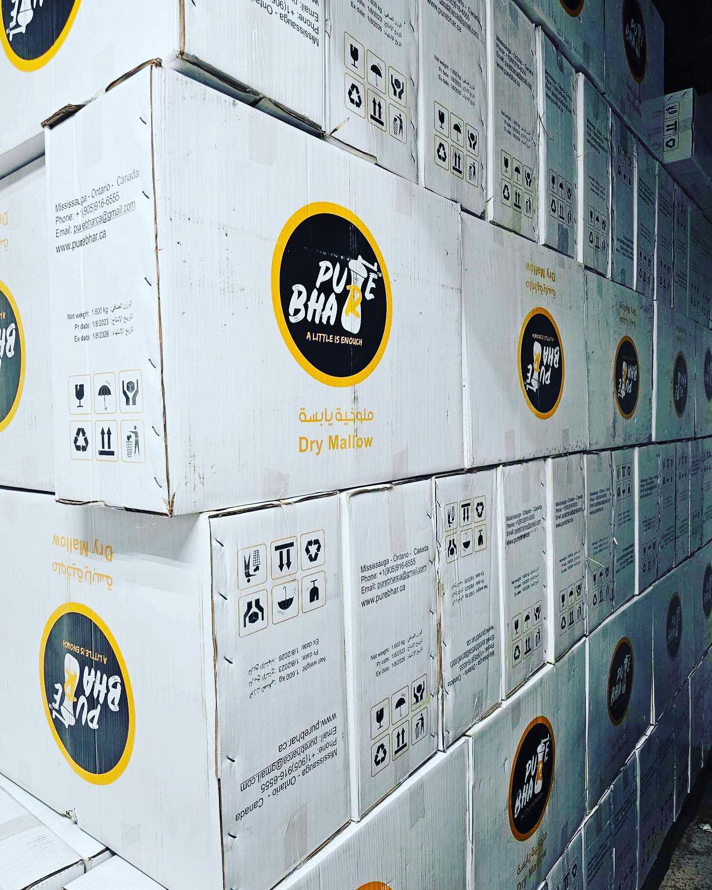 A group of white boxes stacked in a warehouse labeled pure BHA