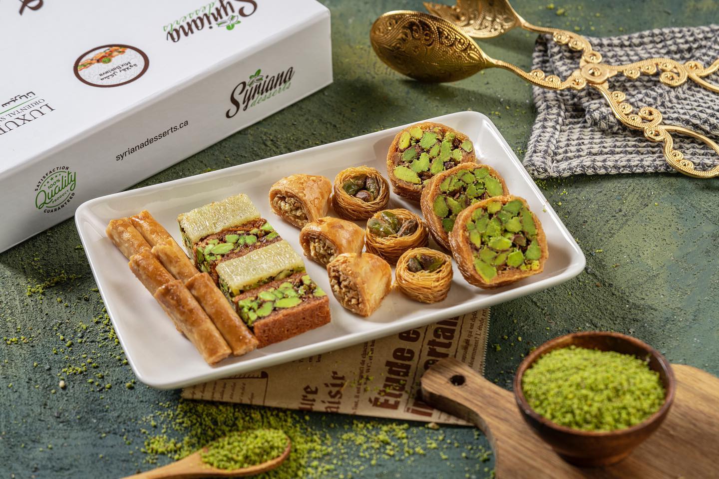 A variety of oriental sweets including baklava and other pastries decorated with pistachios.