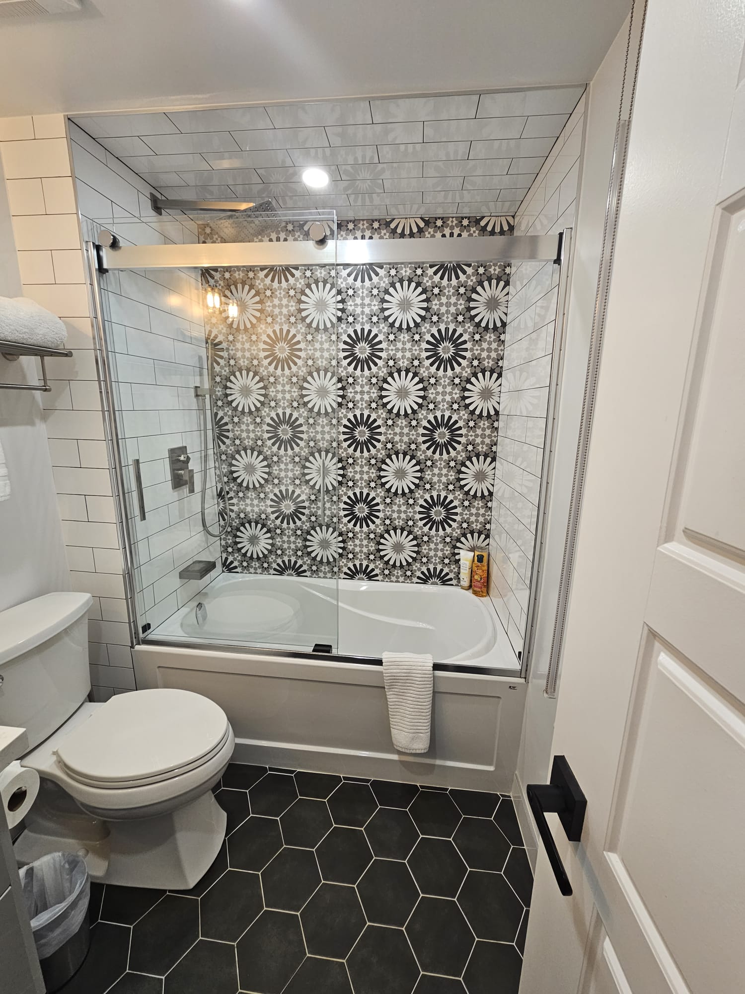 Modern bathroom featuring a contemporary design with a bathtub and sliding glass door.