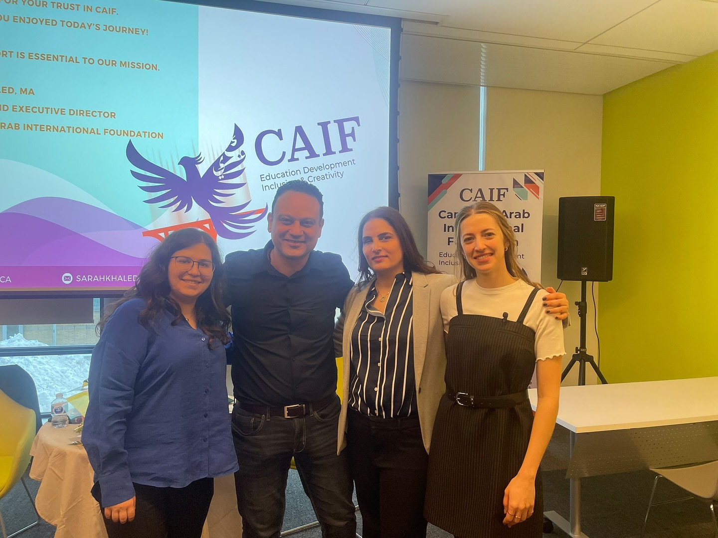 Four people standing together at an event related to CAIF - Focusing on development and creativity
